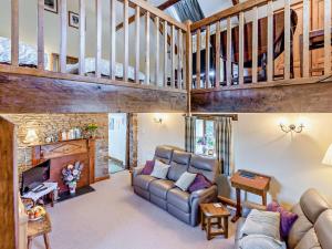 a living room with a couch and a fireplace at 3 bed property in Bideford HONEY in Frithelstock