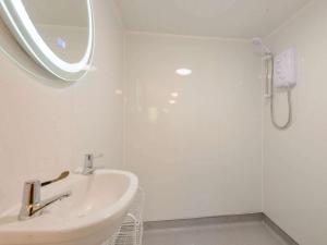 a white bathroom with a sink and a shower at 1 Bed in Conwy 79464 in Conwy +24 photos
