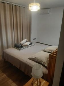 a bedroom with a large bed with a lamp at Villa 4 étoiles Bon Air in Bouillante +34 photos