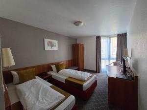 Ein Bett oder Betten in einem Zimmer der Unterkunft Concorde Hotel Ascot