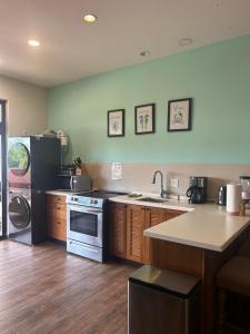 a kitchen with a refrigerator and a stove top oven at Villa amana El sitio in Playa Venao