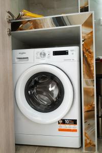 a white washing machine in a kitchen at Cozy Garden View Apartment in Paralia in Paralia Katerinis +19 photos
