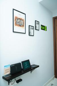 two laptops sitting on a shelf on a wall at Cozy Garden View Apartment in Paralia in Paralia Katerinis