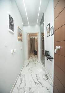 a room with a marble floor and a hallway at Cozy Garden View Apartment in Paralia in Paralia Katerinis