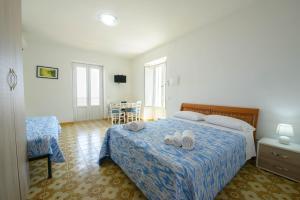a bedroom with a bed with two towels on it at Panorama Carmelina in Ischia