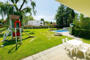 a yard with a playground with a slide at Holiday home in Balatonmariafürdo 38170 in Balatonmáriafürdő