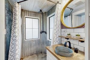 a bathroom with a sink and a mirror at Chimney Rock Tiny Home in Canyon Lake +14 photos