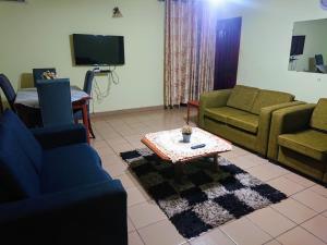 a living room with couches and a coffee table at Divine Grace Guesthouse in Yaoundé
