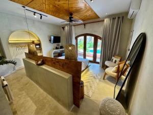 a living room with a bed and a tv in a room at Kai Zanzibar Hotel and Spa in Nungwi