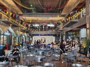 a group of people sitting in a restaurant at Tropics City Supreme Black Theme Large Balcony City View至尊黑主题大阳台城市风景民宿 in Kuching
