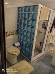 a bathroom with a toilet and a shower at Angelikis Shared Home in Pírgos