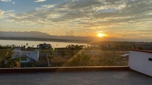 una vista de la puesta de sol desde el techo de un edificio en House in Teques Rooftop with view and pool for 15, en Tequesquitengo