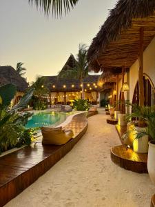 a resort with a swimming pool and a resort at Kai Zanzibar Hotel and Spa in Nungwi