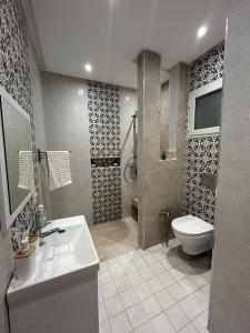 a bathroom with a toilet and a sink and a shower at Dar Omi Aïcha in Kerkouene +19 photos