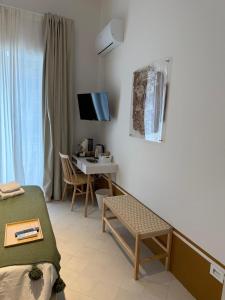 a bedroom with a desk and a bed and a table at Tresette Porta Capuana in Naples +44 photos