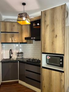 eine Küche mit Herd und Mikrowelle in der Unterkunft ORTUS Murree 2 in Murree