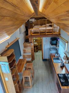 a tiny house with a kitchen and a bunk bed at Tiny House Nativa in Montecarlo +18 photos