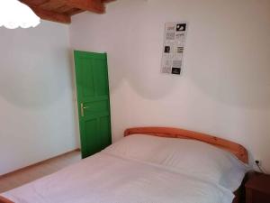 a bedroom with a green door and a bed at Holiday home in Balatonbereny 38081 in Balatonberény