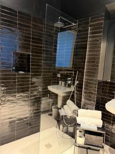 a bathroom with a shower and a toilet and a sink at Tresette Porta Capuana in Naples