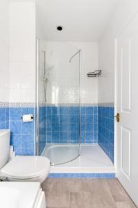 a bathroom with a shower and a toilet and a tub at Peaceful house 10 min walk to beach & parking in Falmouth +23 photos