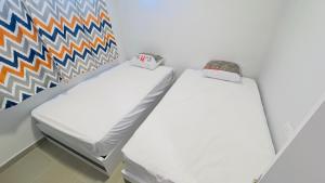 two beds in a room with a colorful wall at Porto Matrouh Unique Chalet 81003 in Marsa Matruh +14 photos