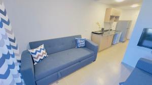 a blue couch in a living room with a kitchen at Porto Matrouh Unique Chalet 81003 in Marsa Matruh