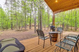 a screened in porch with chairs and a grill at Unwind Fireside! Home 30 Mi to Sunrise Ski Resort in Pinetop