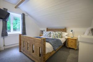 a bedroom with a wooden bed and a sink at Moss Crag in Penrith