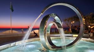 a pool with two water fountains in the middle at Dreamland Oasis 1 Studio in Chakvi +11 photos