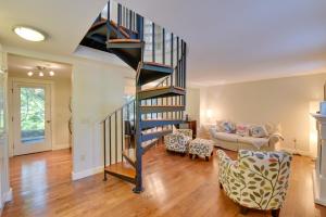a living room with a spiral staircase and a couch at Provincetown Condo Half Mi to Historic District! in Provincetown