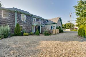 a house with a gravel driveway in front of it at Provincetown Condo Half Mi to Historic District! in Provincetown