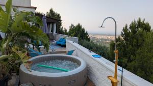 a hot tub on the side of a house at Bellavista in Selva di Fasano