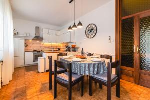 a kitchen and dining room with a table and chairs at Kuća za odmor GOTA 