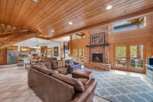 a living room with a couch and a fireplace at Authentic log cabin minutes from Zion NP in Orderville