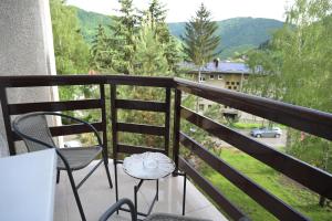 a balcony with a table and chairs and a view at Apartman Castello in Jajce