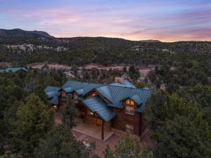 an aerial view of a house with a blue roof at Authentic log cabin minutes from Zion NP in Orderville