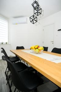 a dining room table with a bowl of fruit on it at Apartman Castello in Jajce