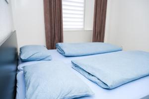 two beds in a room with blue pillows on them at Apartman Castello in Jajce +5 photos