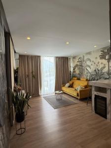 a living room with a yellow couch in a room at Super Luxury Apartment Ocean View Las Americas Costa Adeje in Adeje +27 photos