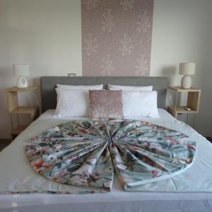 a bed with a blanket on top of it at Val&Sol Apartments in Sečovlje