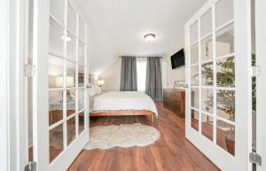 a bedroom with a bed and sliding glass doors at Vineyard Cottage in Wine Country with Hot Tub in Jonesville