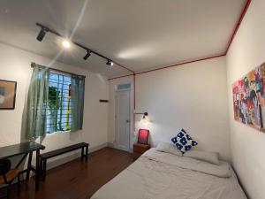a bedroom with a bed and a desk and a window at 88 ngày là tới HOUSE - 88 days to go HOUSE in Da Nang