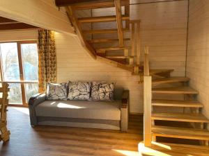 a room with a couch and stairs in a house at На Замковiй горi in Kosiv