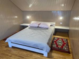 a bedroom with a bed in a small room at На Замковiй горi in Kosiv +8 photos