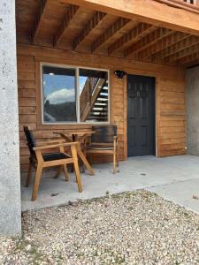 a wooden house with a bench and a window at Cowboy Hot Tub and Alleged Alien Sightings in Alton