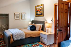 a small bedroom with a bed and a night stand at Creek-Hot Tub-View-Pets-10min DT in Durango