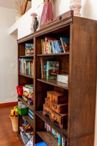a wooden book shelf filled with books at Creek-Hot Tub-View-Pets-10min DT in Durango