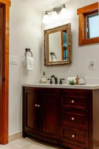 a bathroom with a sink and a mirror at Creek-Hot Tub-View-Pets-10min DT in Durango +79 photos