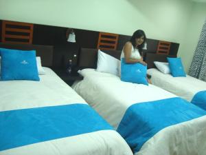 Postel nebo postele na pokoji v ubytování Hotel de las Américas - Ambato