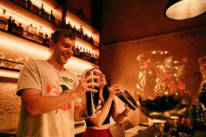 a man and a woman holding a glass of wine at Viajero Arequipa Hostel in Arequipa